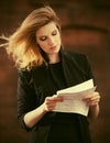 Young fashion business woman in black blazer reading tax letter Royalty Free Stock Photo