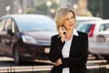 Young fashion business woman calling on cell phone walking in city street Royalty Free Stock Photo