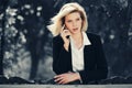 Young fashion business woman calling on cell phone in city park Royalty Free Stock Photo