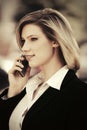 Young fashion business woman calling on cell phone in city street Royalty Free Stock Photo