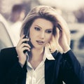 Young fashion business woman calling on cell phone on city street Royalty Free Stock Photo