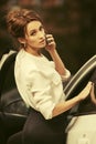 Young fashion business woman calling on cell phone outside a her car Royalty Free Stock Photo