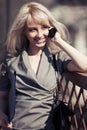 Young fashion business woman with a folder calling on cell phone Royalty Free Stock Photo