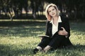 Young fashion business woman with a folder working in a city park Royalty Free Stock Photo