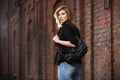 Young fashion business woman with handbag walking on city street Royalty Free Stock Photo