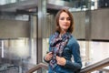 Young fashion business woman leaning on railing in office interior Royalty Free Stock Photo