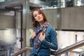 Young fashion business woman leaning on railing in office interior Royalty Free Stock Photo