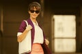 Young fashion business woman in purple blazer and sunglasses with handbag Royalty Free Stock Photo