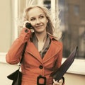 Young fashion business woman in red leather coat calling on cell phone Royalty Free Stock Photo