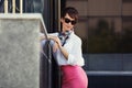 Young fashion business woman in white shirt and pink skirt Royalty Free Stock Photo