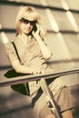 Young fashion business woman in sunglasses talking on cell phone Royalty Free Stock Photo