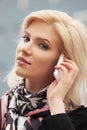 Young fashion business woman talking on cell phone walking on city street Royalty Free Stock Photo