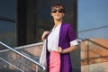 Young fashion business woman in purple blazer and sunglasses