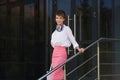 Young fashion business woman in white blouse and pink skirt Royalty Free Stock Photo