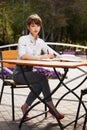 Young fashion business woman working at sidewalk cafe Royalty Free Stock Photo