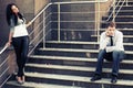 Young fashion couple in conflict on the steps Royalty Free Stock Photo