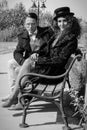 Young fashion elegant stylish retro couple sitting on bench Royalty Free Stock Photo