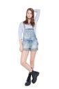 Young fashion girl in jeans overalls posing isolated Royalty Free Stock Photo