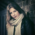 Young fashion girl with long hairs next to brick wall Royalty Free Stock Photo