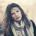 Young fashion girl in white knitted scarf walking outdoor Royalty Free Stock Photo