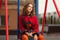 Young fashion hipster woman sitting on the swing Royalty Free Stock Photo