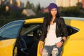 Young fashion hipster woman in leather jacket leaning on her car Royalty Free Stock Photo