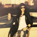 Young fashion hipster woman in sunglasses leaning on her car Royalty Free Stock Photo