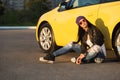 Young fashion hipster woman sitting next to her car Royalty Free Stock Photo