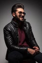 Young fashion man with long beard laughing while looking away Royalty Free Stock Photo