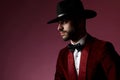 Young fashion man looking to side and wearing red velvet tuxedo Royalty Free Stock Photo