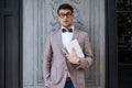 Young fashion man with nerd glasses and stylish hairdo posing Royalty Free Stock Photo