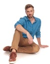 Young fashion man posing while lying on the floor Royalty Free Stock Photo