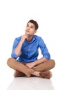 Young fashion man sitting with his legs crossed Royalty Free Stock Photo