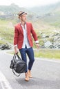 Young fashion man walks on the road Royalty Free Stock Photo