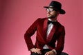 Young fashion man wearing red velvet tuxedo and looking to side Royalty Free Stock Photo