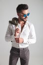 Young fashion man wearing sunglasses looks away to a side Royalty Free Stock Photo