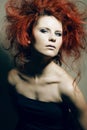 Young fashion model with curly red hair.