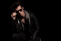 Young fashion model in leather jacket taking off his sunglasses Royalty Free Stock Photo