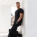 Young fashion model man with bag in black shirt Royalty Free Stock Photo