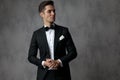 Young fashion model wearing black tuxedo and looking to side Royalty Free Stock Photo