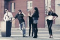 Young fashion people calling on cell phones on city street Royalty Free Stock Photo