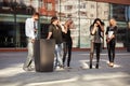 Young fashion people calling on cell phones in city street Royalty Free Stock Photo