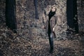 Young fashion woman in classic coat walking in autumn forest Royalty Free Stock Photo