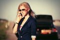 Young fashion woman next to broken car calling on cell phone Royalty Free Stock Photo