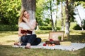 Young fashion woman reading a book in a city park Royalty Free Stock Photo
