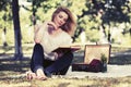 Young fashion woman reading a book in city park Royalty Free Stock Photo