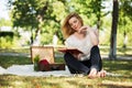 Young fashion woman reading a book in the park Royalty Free Stock Photo