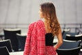 Young fashion woman in red tweed jacket and skirt suit at sidewalk cafe Royalty Free Stock Photo