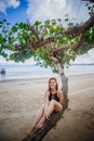 Young fashion woman relax on the beach. Happy island lifestyle. White sand, blue cloudy sky and crystal sea of tropical beach. Royalty Free Stock Photo