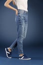 Young fashion woman`s legs in blue denim jeans Royalty Free Stock Photo